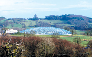 The great glass house nesled in the hill.